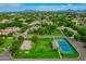 Expansive aerial view of a residential neighborhood featuring tennis courts, mature trees, manicured lawns and mountain views at 1440 N 40Th St # 4, Mesa, AZ 85205