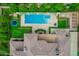 Overhead shot of pool featuring diving board, hot tub, columned patio, and well maintained lawn at 1440 N 40Th St # 4, Mesa, AZ 85205