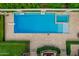 Overhead shot of pool and hot tub featuring diving board and travertine patio with beautifully landscaped lawn at 1440 N 40Th St # 4, Mesa, AZ 85205