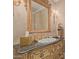 Vanity in a bathroom with gold fixtures and ornate mirror at 1440 N 40Th St # 4, Mesa, AZ 85205