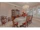 Formal dining room featuring a long table with seating for eight, a chandelier, and a decorative china cabinet at 1440 N 40Th St # 4, Mesa, AZ 85205