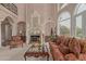 Elegant living room featuring a fireplace with mantle, comfortable seating, and a large arched window at 1440 N 40Th St # 4, Mesa, AZ 85205