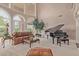 Bright living room featuring large arched windows, comfortable seating, and a grand piano at 1440 N 40Th St # 4, Mesa, AZ 85205