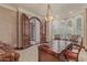 Luxurious home office featuring custom wood desk, arched doorways, and natural light from large windows at 1440 N 40Th St # 4, Mesa, AZ 85205