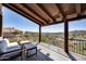 A covered balcony offers seating and beautiful views of the surrounding landscape at 15101 E Aspen Dr, Fountain Hills, AZ 85268