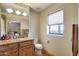 Well-lit bathroom featuring granite countertops, a window with a view, and ample storage at 15101 E Aspen Dr, Fountain Hills, AZ 85268