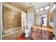 A bathroom with a tub and shower combination, tiled walls, and a granite countertop vanity at 15101 E Aspen Dr, Fountain Hills, AZ 85268