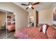 Comfortable bedroom featuring a ceiling fan, closet with mirrored doors, and access to other areas of the house at 15101 E Aspen Dr, Fountain Hills, AZ 85268