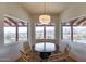 Bright breakfast nook featuring mountain views through large picture windows and a modern light fixture at 15101 E Aspen Dr, Fountain Hills, AZ 85268