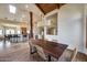 Open-concept dining room with wood floors, large wooden table, and island seating at 15101 E Aspen Dr, Fountain Hills, AZ 85268