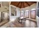 A charming dining room with wood-look tile floor, wooden ceiling and arched windows with wood shutters at 15101 E Aspen Dr, Fountain Hills, AZ 85268