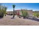 Side view of a desert home with a three-car garage and desert foliage surrounding the property at 15101 E Aspen Dr, Fountain Hills, AZ 85268