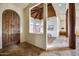 Foyer with a rustic wooden door, stone floors and a peek into the open-concept living spaces at 15101 E Aspen Dr, Fountain Hills, AZ 85268