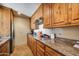 Kitchen area featuring stainless steel appliances, granite countertops, and dark wood cabinets at 15101 E Aspen Dr, Fountain Hills, AZ 85268