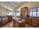 Kitchen island with sink and stainless appliances, custom cabinets, and dining area in background at 15101 E Aspen Dr, Fountain Hills, AZ 85268