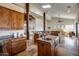 Kitchen with wood beams, granite countertops, island sink, high-end appliances, and stone floors at 15101 E Aspen Dr, Fountain Hills, AZ 85268