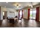 An open living space with dark wood floors, modern seating, and sliding glass doors to the outdoor space at 15101 E Aspen Dr, Fountain Hills, AZ 85268