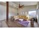 Spacious living room with a large ceiling fan, modern furniture, wood flooring, and a cactus themed decor at 15101 E Aspen Dr, Fountain Hills, AZ 85268