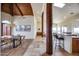 Open-concept living spaces featuring wood beam posts, travertine floors and vaulted wood beam ceiling at 15101 E Aspen Dr, Fountain Hills, AZ 85268