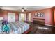 Main bedroom featuring hardwood floors, a ceiling fan, a walk-in closet and ensuite bath at 15101 E Aspen Dr, Fountain Hills, AZ 85268