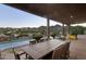 Covered outdoor patio featuring an outdoor dining table, and a stunning view of the swimming pool and desert landscape at 15101 E Aspen Dr, Fountain Hills, AZ 85268