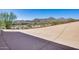 A large paved patio offers breathtaking views of a desert community nestled among rugged mountains at 15101 E Aspen Dr, Fountain Hills, AZ 85268