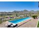 Inviting pool with lounge chairs, mountain views, and lush landscaping at 15101 E Aspen Dr, Fountain Hills, AZ 85268