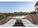 Inviting swimming pool with chaise lounges and a table, overlooking a beautiful desert landscape at 15101 E Aspen Dr, Fountain Hills, AZ 85268