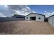Expansive backyard with a covered patio, enclosed by a block fence for privacy at 15761 W Beryl Ave, Waddell, AZ 85355