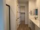 Bathroom featuring a double vanity, tile flooring, and a walk-in closet at 15761 W Beryl Ave, Waddell, AZ 85355
