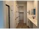Bright bathroom with white cabinets, a large shower, and access to a walk-in closet at 15761 W Beryl Ave, Waddell, AZ 85355