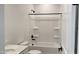 A well-lit bathroom featuring a shower-tub combo, a white vanity, and matte black fixtures at 15761 W Beryl Ave, Waddell, AZ 85355