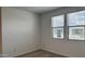 A well-lit bedroom with neutral carpet, a double window, and a clean, simple design at 15761 W Beryl Ave, Waddell, AZ 85355