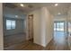 Hallway has wood look tile floor and leads to the bedroom and backyard at 15761 W Beryl Ave, Waddell, AZ 85355