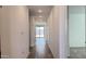 A long hallway with wood-look tile flooring, bright lighting, and access to various rooms at 15761 W Beryl Ave, Waddell, AZ 85355