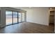 This living room features wood-look flooring, large sliding glass doors and lots of natural light at 15761 W Beryl Ave, Waddell, AZ 85355