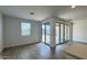 Open living space featuring tile floors, white walls, and a sliding glass door to the backyard at 15761 W Beryl Ave, Waddell, AZ 85355