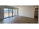 An open concept living room features wood-look tile floors and sliding doors to the backyard at 15761 W Beryl Ave, Waddell, AZ 85355