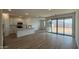 Bright living room featuring wood-look tile floors and sliding doors to the backyard at 15761 W Beryl Ave, Waddell, AZ 85355