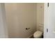 A half bathroom with a standard toilet, neutral walls, and modern black fixtures at 15761 W Beryl Ave, Waddell, AZ 85355
