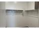 Spacious walk-in closet featuring white shelving and ample storage space at 15761 W Beryl Ave, Waddell, AZ 85355