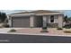 Contemporary single-story home featuring desert landscaping and a gray two-car garage at 15772 W Beryl Ave, Waddell, AZ 85355