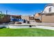 Inviting backyard patio area with a cozy fire pit and comfortable seating, perfect for outdoor relaxation at 162 N 225Th Dr, Buckeye, AZ 85326