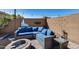 Comfortable backyard seating area features a firepit at 162 N 225Th Dr, Buckeye, AZ 85326