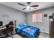 Bedroom featuring a ceiling fan, wood-look flooring, and a video game setup at 162 N 225Th Dr, Buckeye, AZ 85326