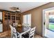 Cozy dining room featuring a wooden table with seating for six and a built-in hutch for storage at 162 N 225Th Dr, Buckeye, AZ 85326