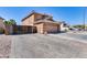 Two story home with a two-car garage, brick driveway and gate at 162 N 225Th Dr, Buckeye, AZ 85326