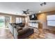 Bright and airy living room featuring large windows and a ceiling fan at 162 N 225Th Dr, Buckeye, AZ 85326