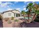 Spacious backyard features a covered patio, lush landscaping, sparkling pool, and serene outdoor living at 16351 W Central St, Surprise, AZ 85388