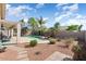 Lush backyard with a sparkling pool, covered patio, and mature landscaping for outdoor enjoyment at 16351 W Central St, Surprise, AZ 85388